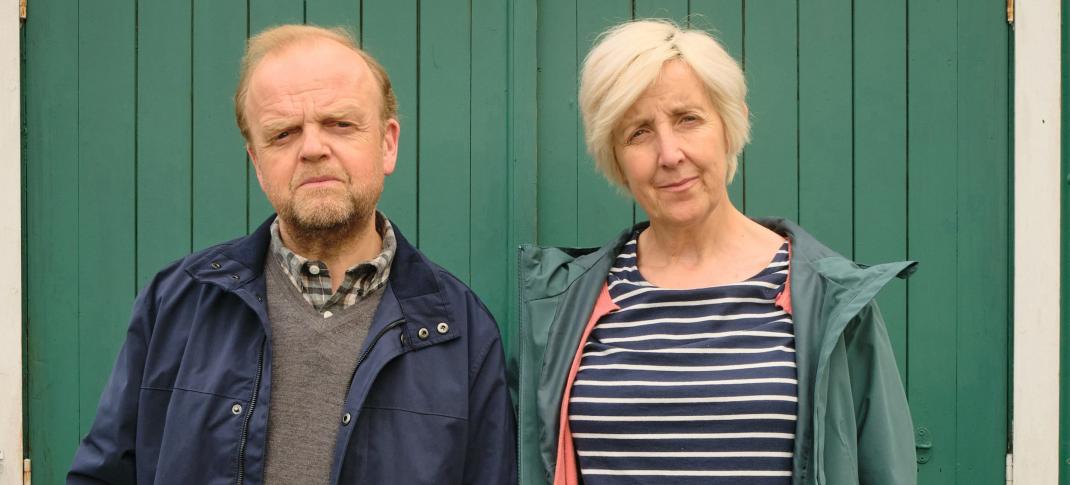 Toby Jones as Alan Bates, Julie Hesmondhalgh as Suzanne Sercombe stand in front of their house in 'Mr Bates vs the Post Office'