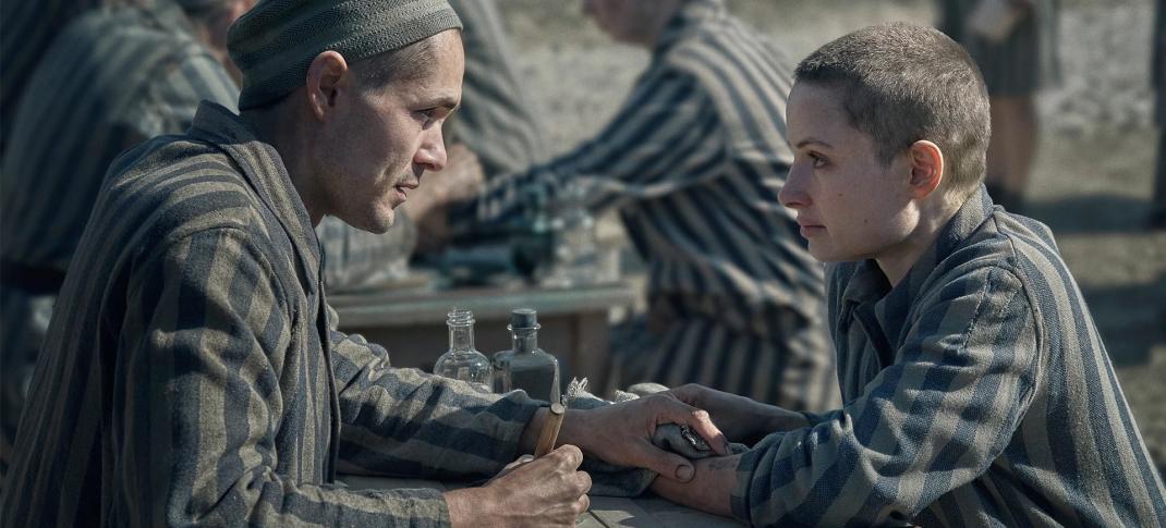 Jonah Hauer King as Lali Sokolov, Anna Próchniak as Gita Furman meet over a tattoo gun in 'The Tattooist of Auschwitz'