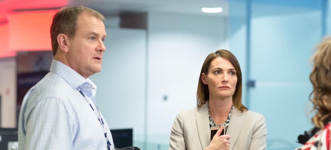 Hugh Bonneville as Ian Fletcher and Sarah Parish as Anna Rampton discuss the value of the news in 'W1A'