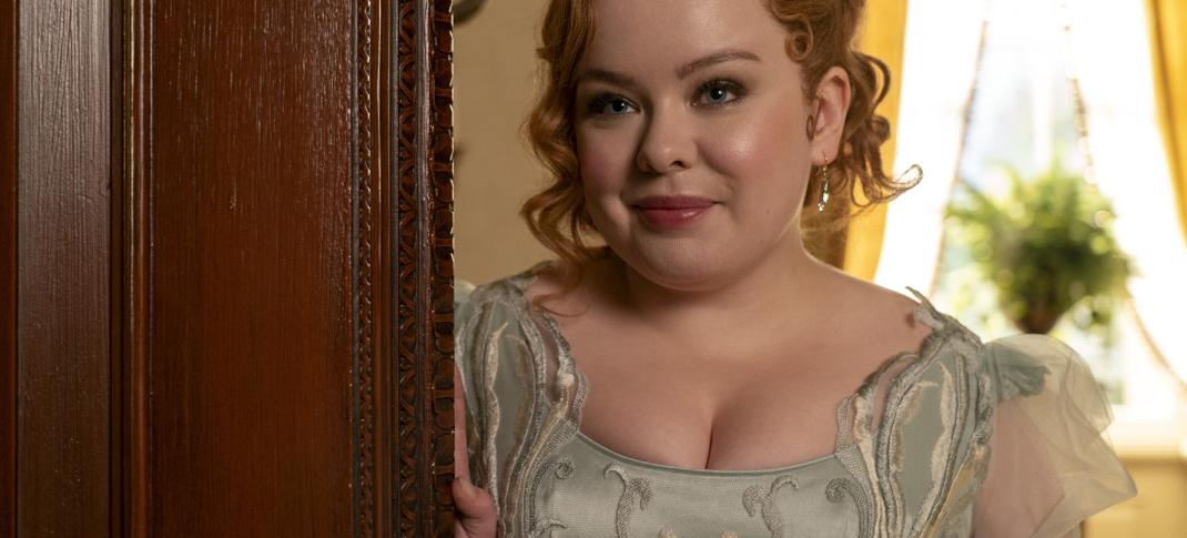 Nicola Coughlan as Penelope Featherington, peeking around the doorway in 'Bridgerton' Season 3