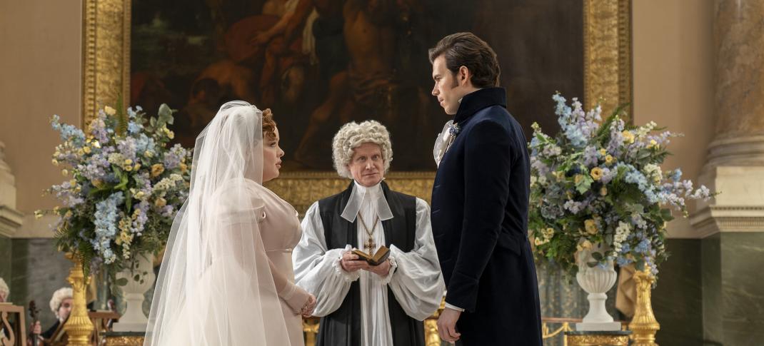 Nicola Coughlan as Penelope Featherton and Luke Newton as Colin Bridgerton at the altar in 'Bridgerton' Season 3