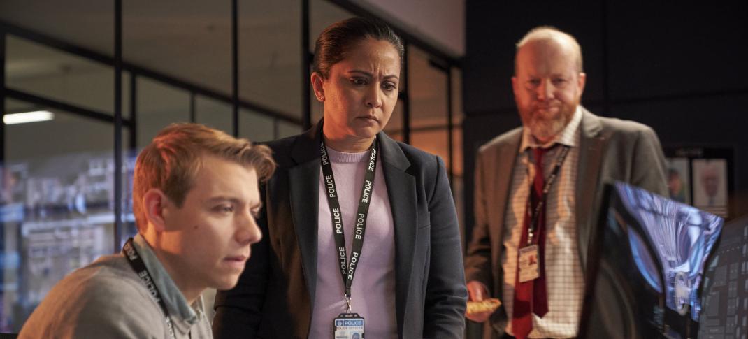 Sam Baker-Jones as DC Liam Payne, Parminder Nagra as DI Rachita Ray, and Steve Oram as DS Clive Bottomley stand around a computer in 'D.I. Ray' Season 2