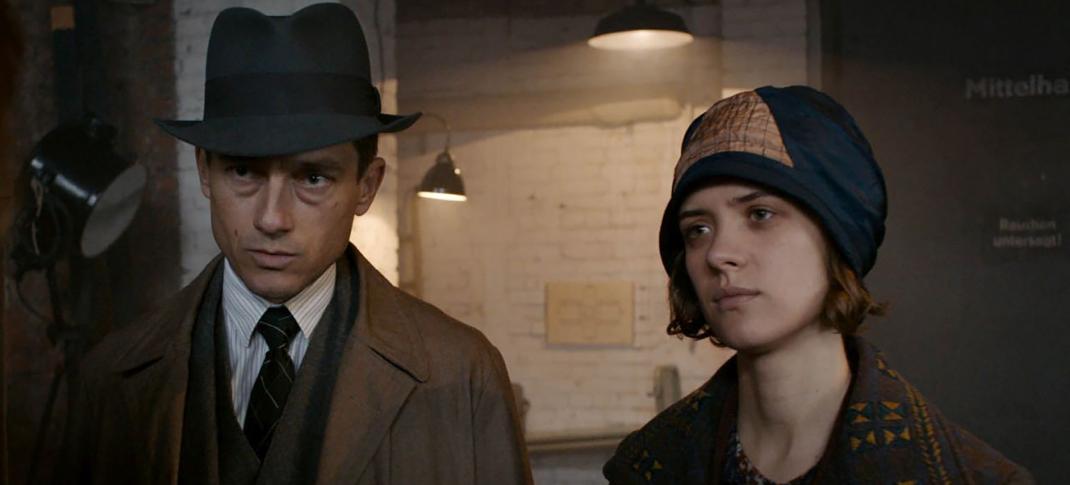 Volker Bruch as Inspector Gereon Rath and Liv Lisa Fries as Charlotte Ritter question a suspect in 'Babylon Berlin' Season 3