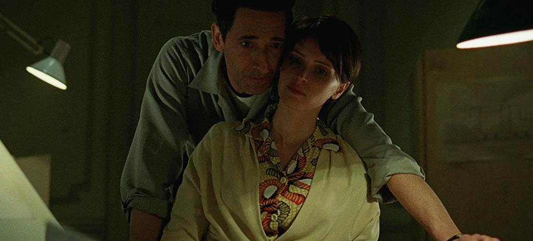 Adrien Brody as László Tóth and Felicity Jones as Erzsébet Tóth in 'The Brutalist'