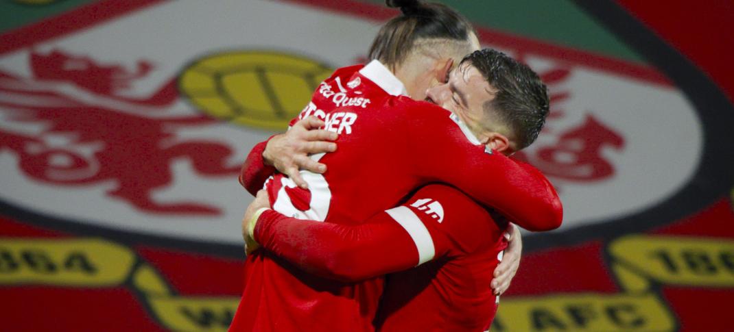 Players Steven Fletcher and Elliot Lee celebrate on the pitch of 'Welcome to Wrexham' Season 4