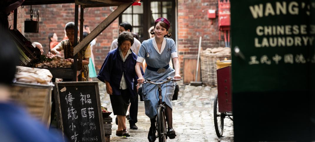 Nurse Gilbert (Charlotte Ritchie) peddles to her next appointment  Photo: Courtesy of Neal Street Productions 2016)