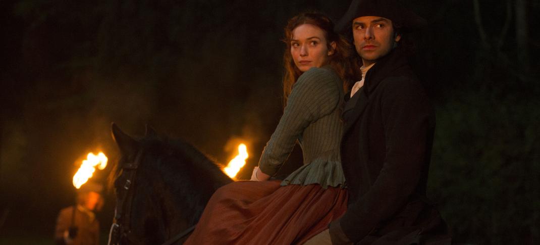 Ross and Demelza and dramatic firelight from the local riot. (Photo: Courtesy of Mammoth Screen for BBC and MASTERPIECE)