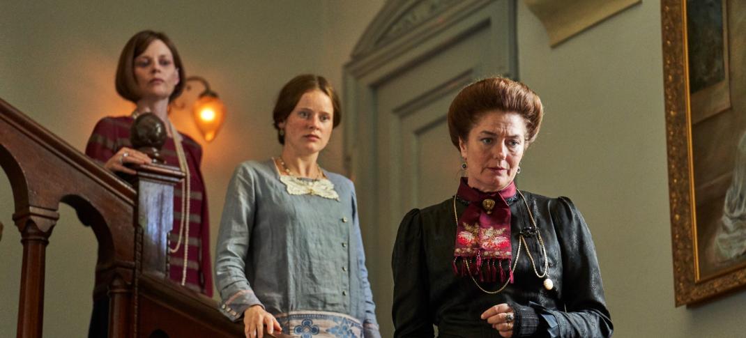 Lucy Akhurst as Julia Drummond-Ward, Claude Scott-Mitchell as Rose Drummond-Ward, and Anna Chancellor as Lady Latchmere on the stairs in 'Hotel Portofino' Season 1