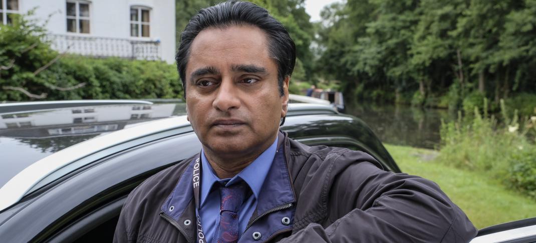 Sanjeev Bhaskar as DS Sunny Khan standing by the car in Unforgotten Season 2