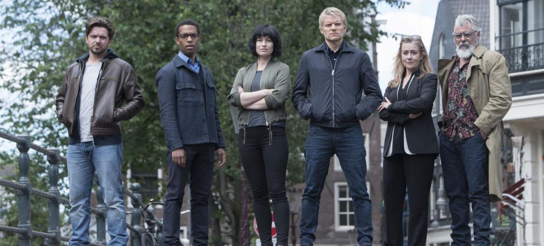 Luke Allen-Gale as Sgt Brad de Vries, Elliot Barnes-Worrell as Sgt Job Cloovers, Maimie McCoy as DS Lucienne Hassell, Marc Warren as DC Piet Van der Valk, Emma Fielding as DCS Julia Dahlman, Darrell D'Silva as Dr. Hendrik Davie pose for the Van der Valk Season 1 Key Art