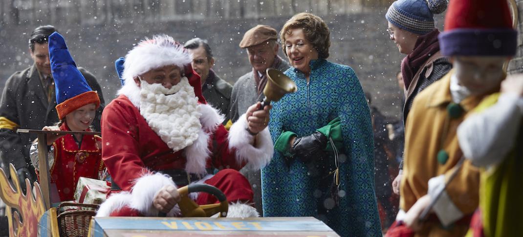 Fred Buckle (CLIFF PARISI) drives his rocket sleigh through Poplar as his wife Violet (ANNABELLE APSION) looks on (Photo Credit: Courtesy of Neal Street Production/BBC)