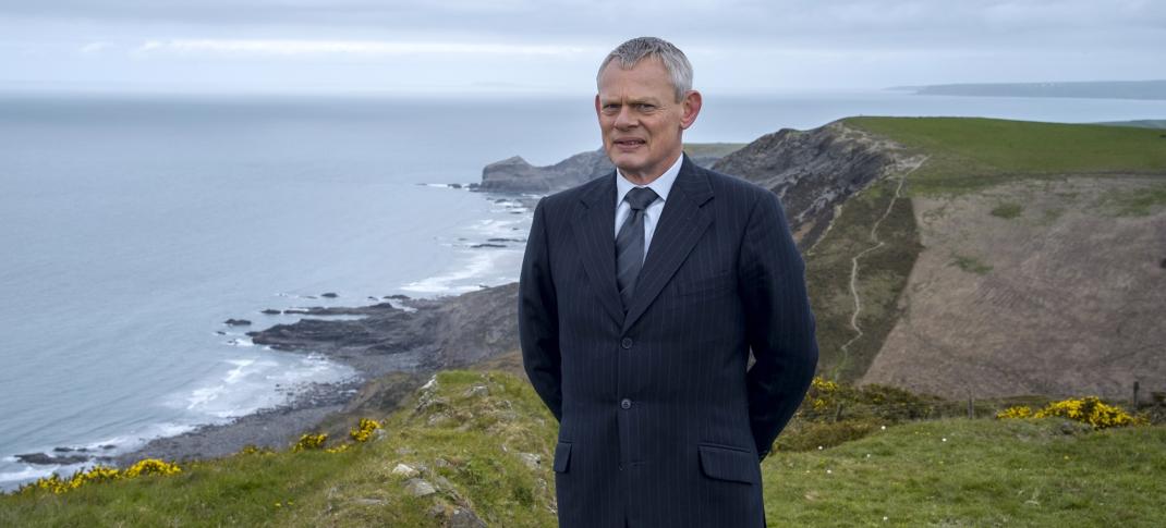 Martin Clunes as the titular 'Doc Martin' stand on a clifftop in the Season 8 key art