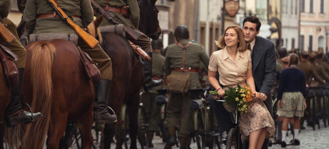 Jonah Hauer-King as Harry Chase and Zofia Wichlacz as Kasia Tomaszeski on a bicycle in 'World on Fire' Season 1